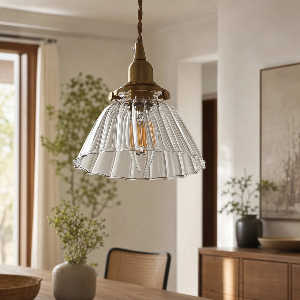 Clear ribbed glass pendant light above a dining area