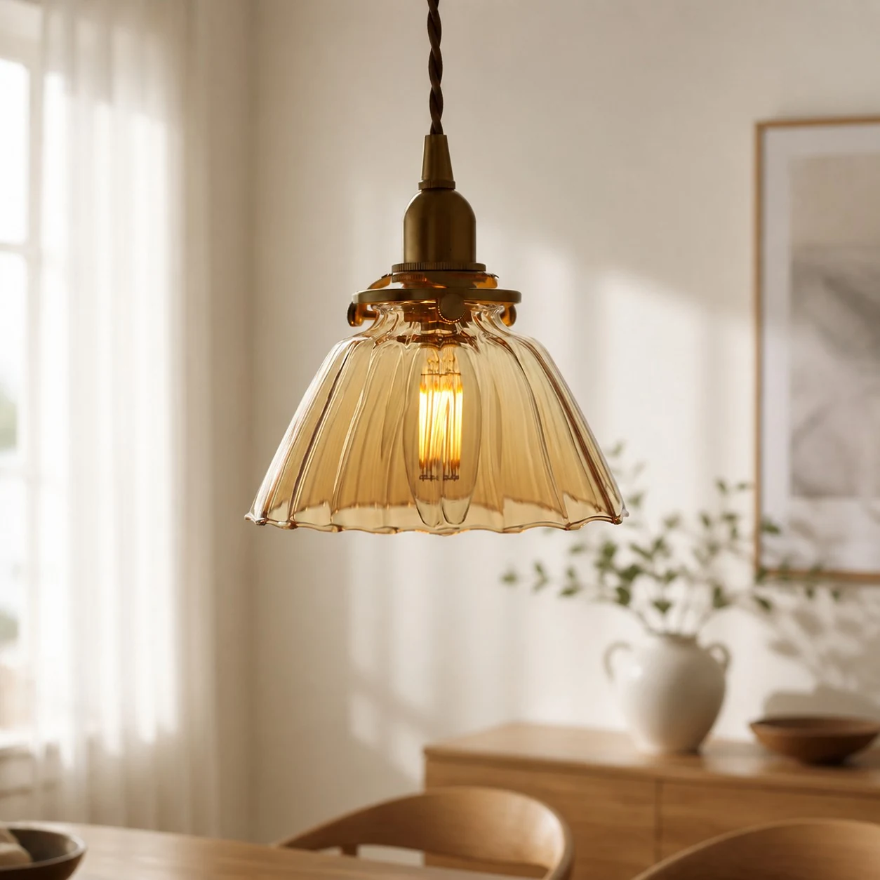 Amber ribbed glass pendant light styled above a dining area