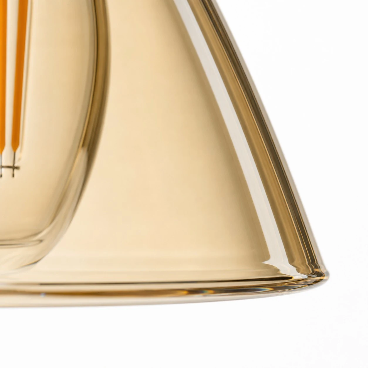Close-up of amber smooth glass shade edge
