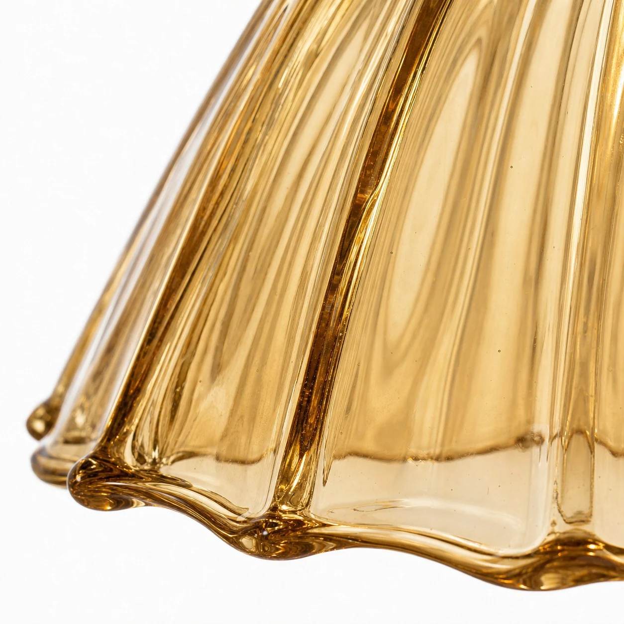 Close-up of amber ribbed glass shade and wavy rim