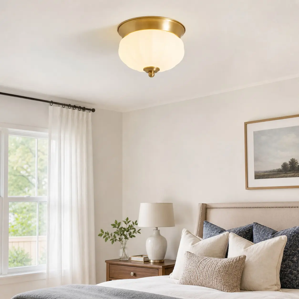 Brass flush mount ceiling light in a calm bedroom