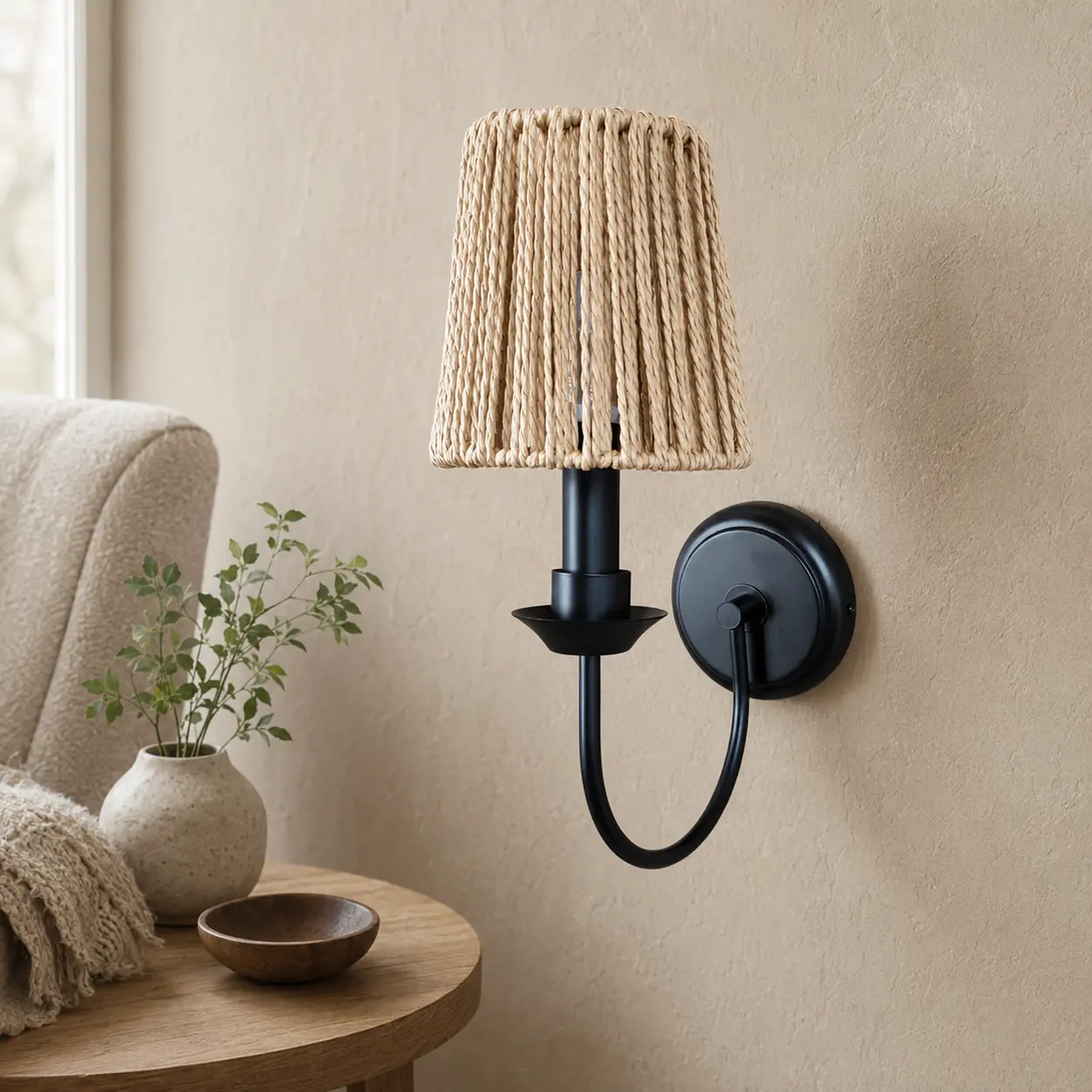 Matte black woven wall sconce in a reading corner