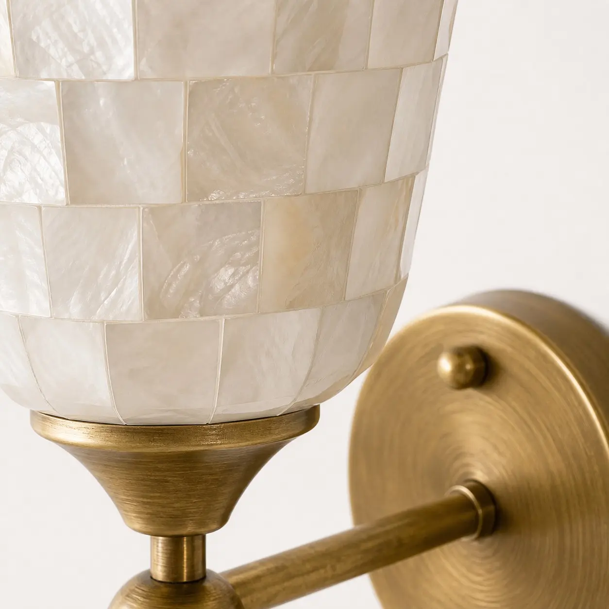 Shell shade and antique brass holder detail