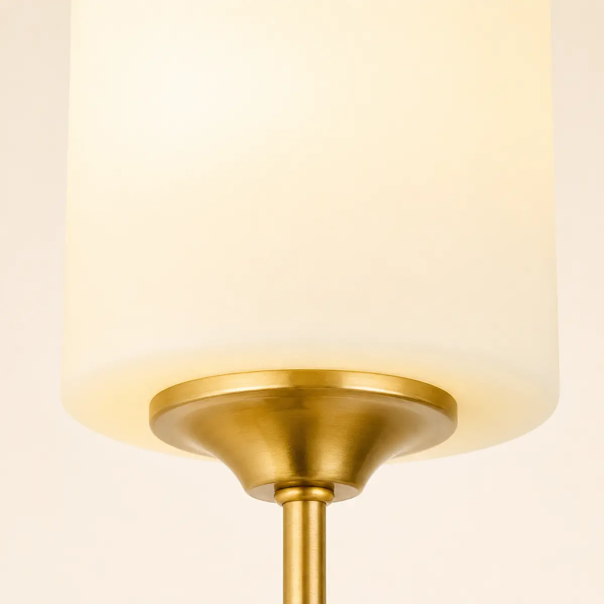 Close view of the cylindrical frosted-glass shade and brass holder