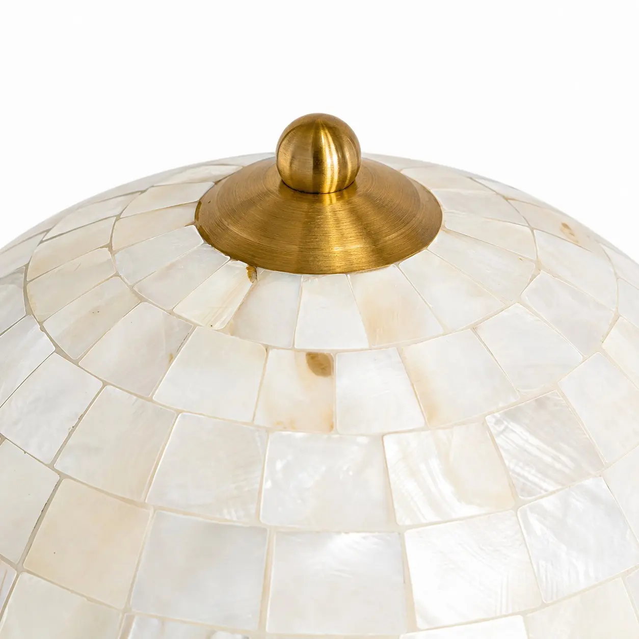 Close-up of the antique brass finial and shell shade craftsmanship