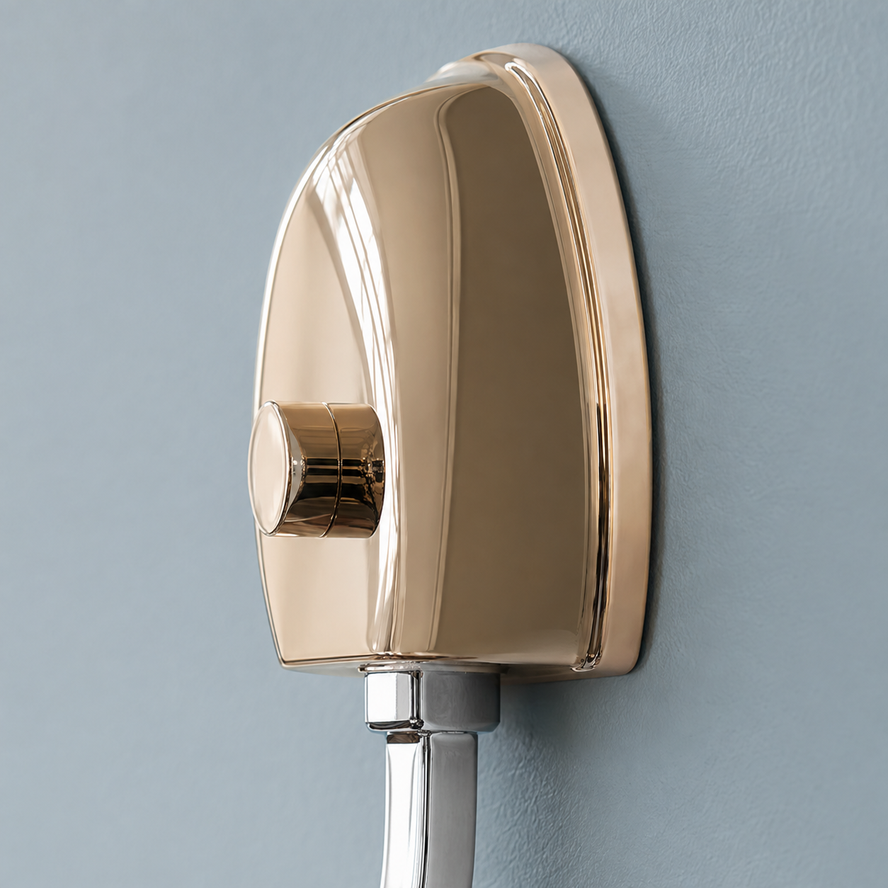 Close-up of the rose gold wall canopy and chrome arm connection