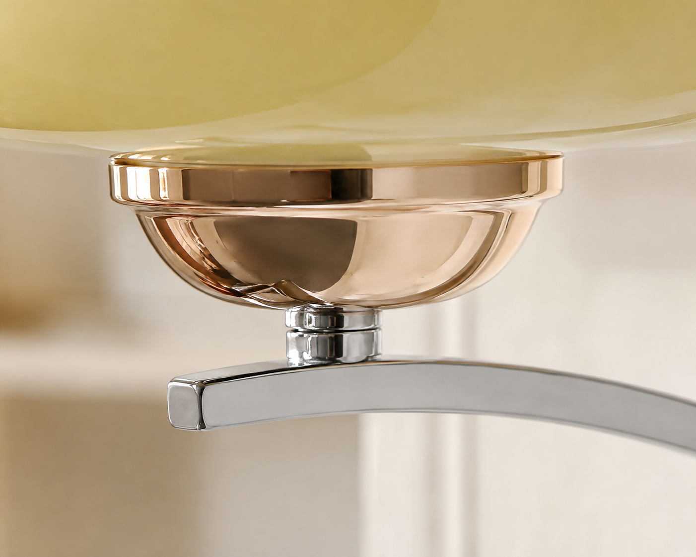 Close-up of the beige glass shade, rose gold holder and chrome arm